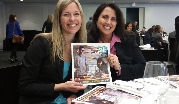 Two women holding up a photo